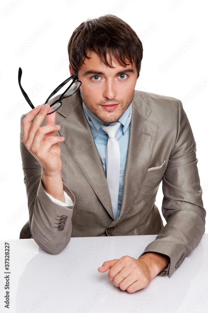 Handsome young man behind desk. Handsome young man behind desk.