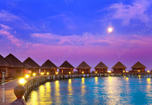 small houses on water on a sunset.. © Konstantin Kulikov