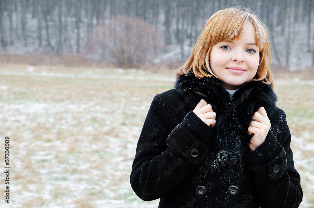 Young blonde woman under snow in winter forest Young blonde woman under snow in winter forest