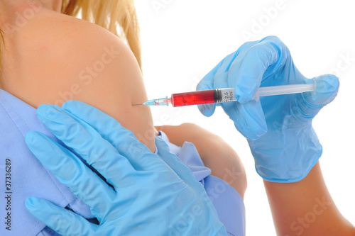 Tablou pe pânză Young doctor makes the patient an injection