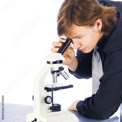 Young College Student Looking Into Microscope