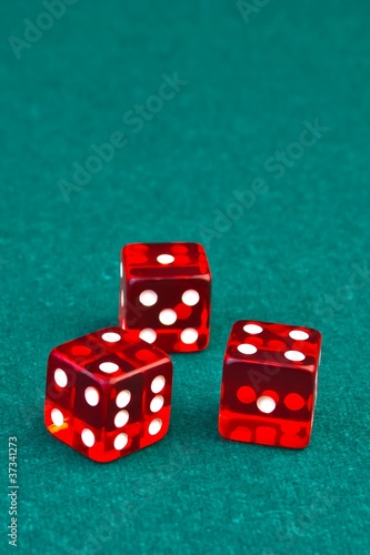 three reds dice on green