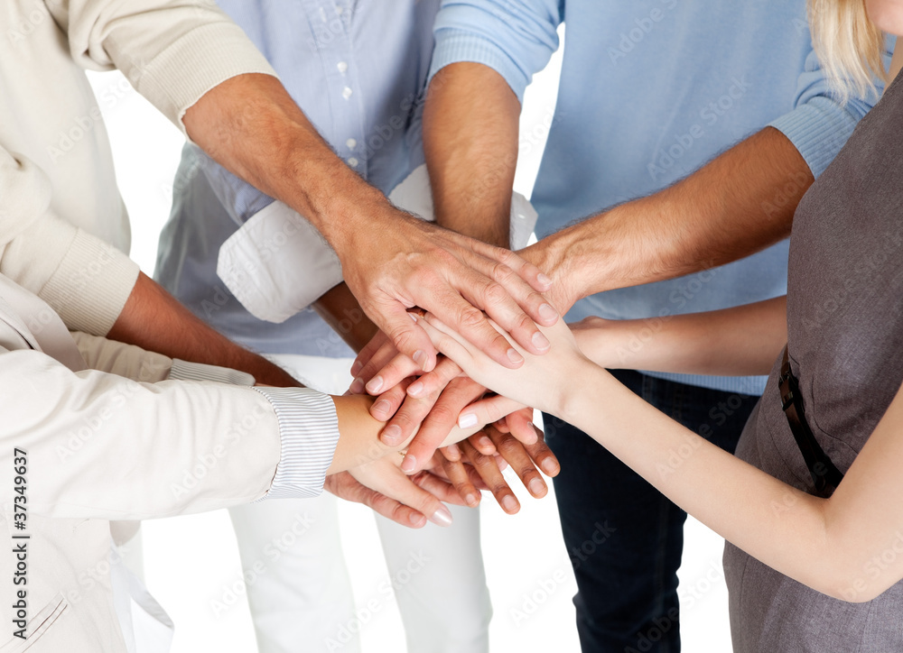 Stacked hands symbolizing team effort Stacked hands symbolizing team effort