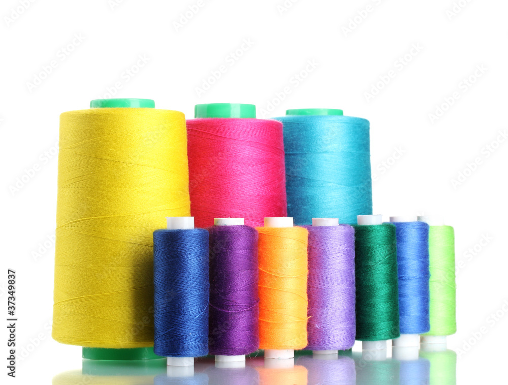 Many-coloured bobbins of thread isolated on white Many-coloured bobbins of thread isolated on white