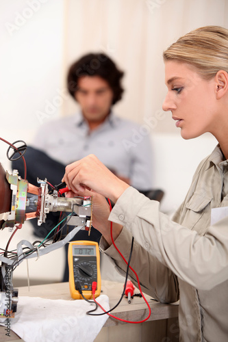 Woman repairing television