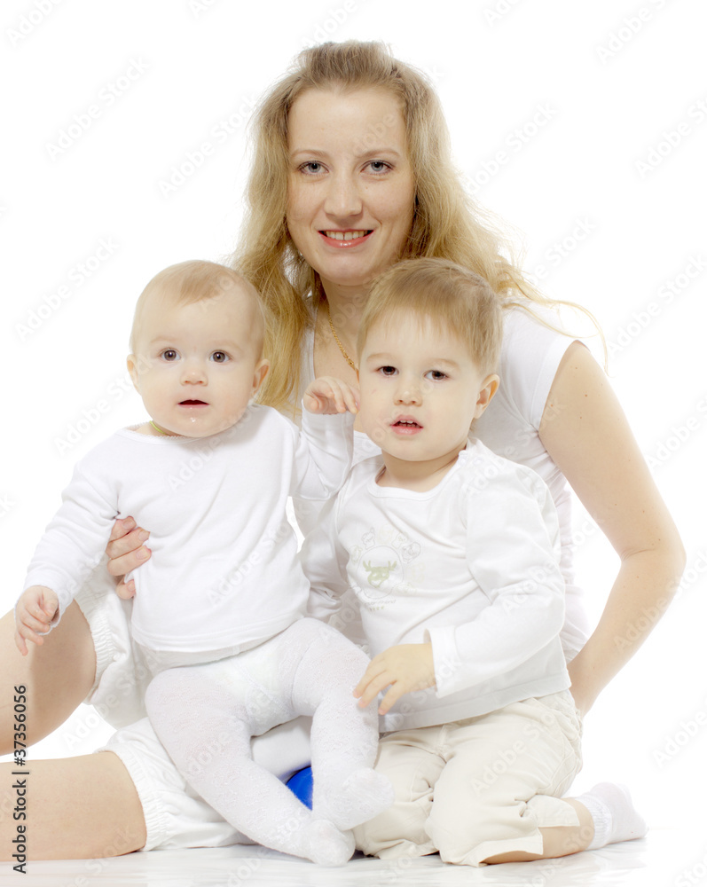 The woman in the white sits with two children The woman in the white sits with two children