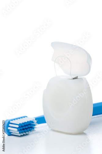 Close-up of dental floss and a toothbrush