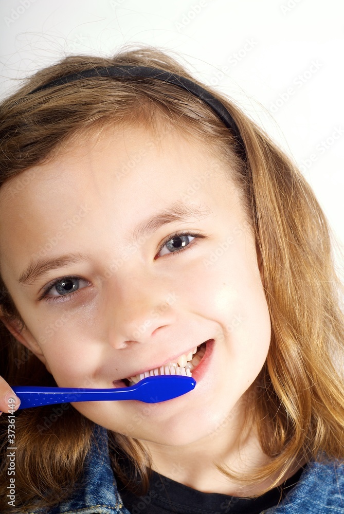 Girl brushing teeth on white background Girl brushing teeth on white background