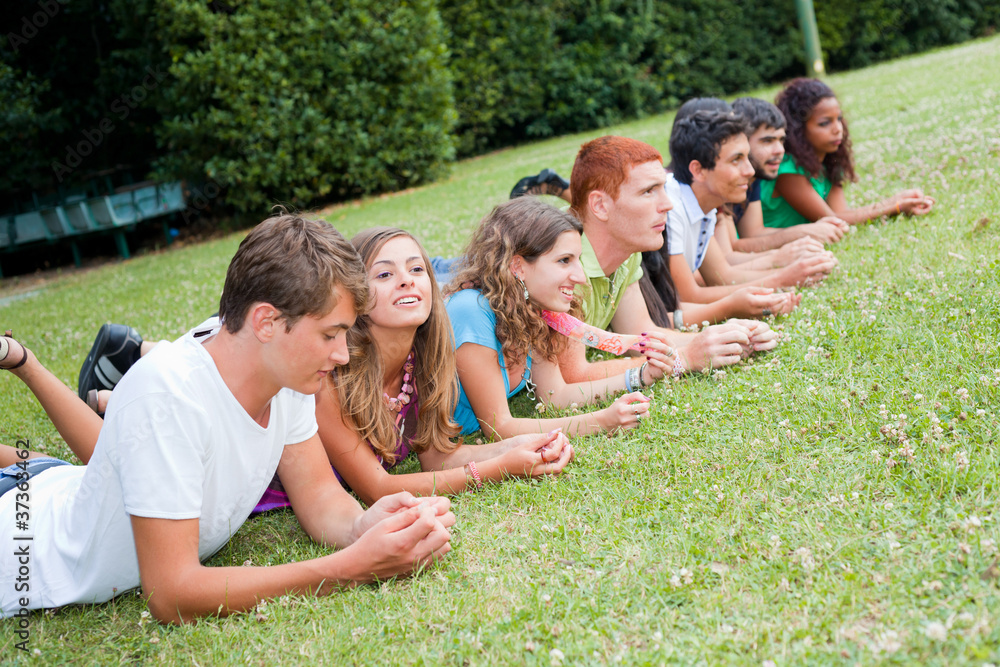 Group of Teenagers Lying on the Ground at Park Group of Teenagers Lying on the Ground at Park