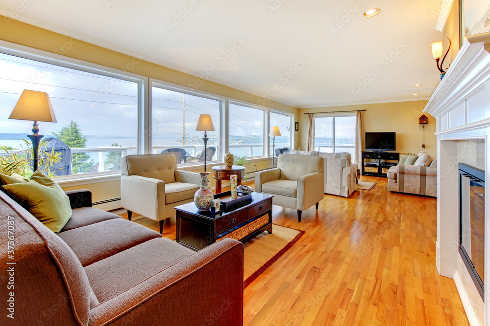 Large luxury living room with many windows and fireplace. Large luxury living room with many windows and fireplace.
