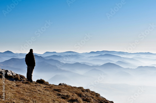 Tablou pe pânză Misty mountain hills and man silhouette