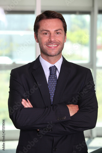 Businessman stood with arms crossed