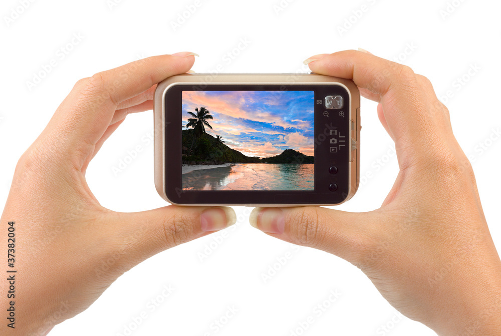 Hand with camera and beach landscape (my photo)