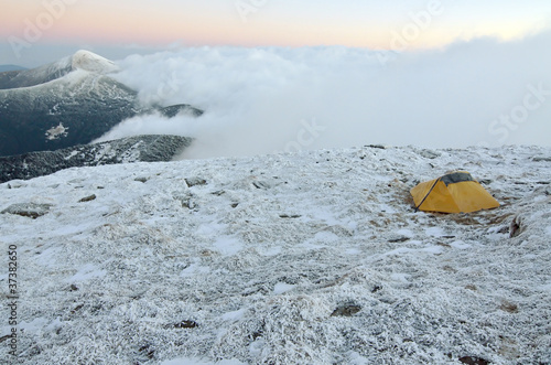 Obraz na płótnie yellow touristic tent on a snowy peak w salonie