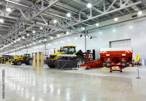 tractors are in room at exhibition, special agricultural machine