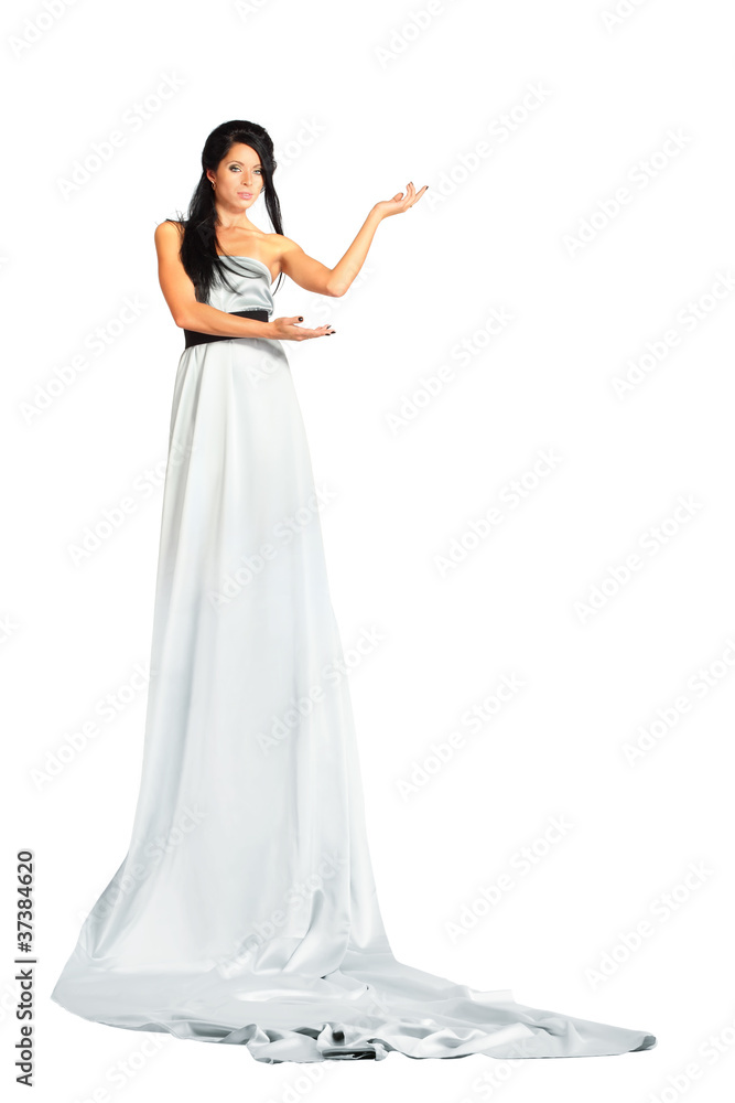 beautiful woman wearing very long silver dress stands