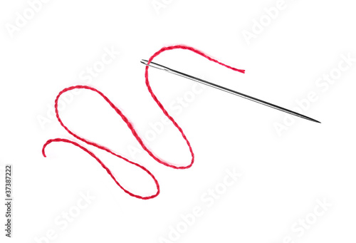 Red thread and needle isolated on white