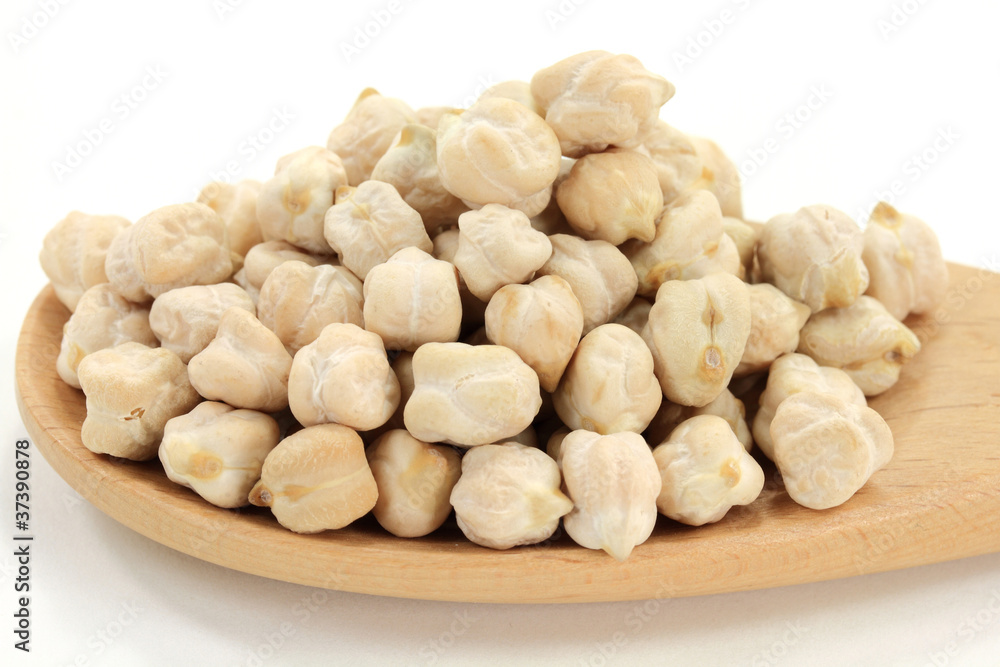 Chick Peas on pile, in wooden cooking spoon. Chick Peas on pile, in wooden cooking spoon.