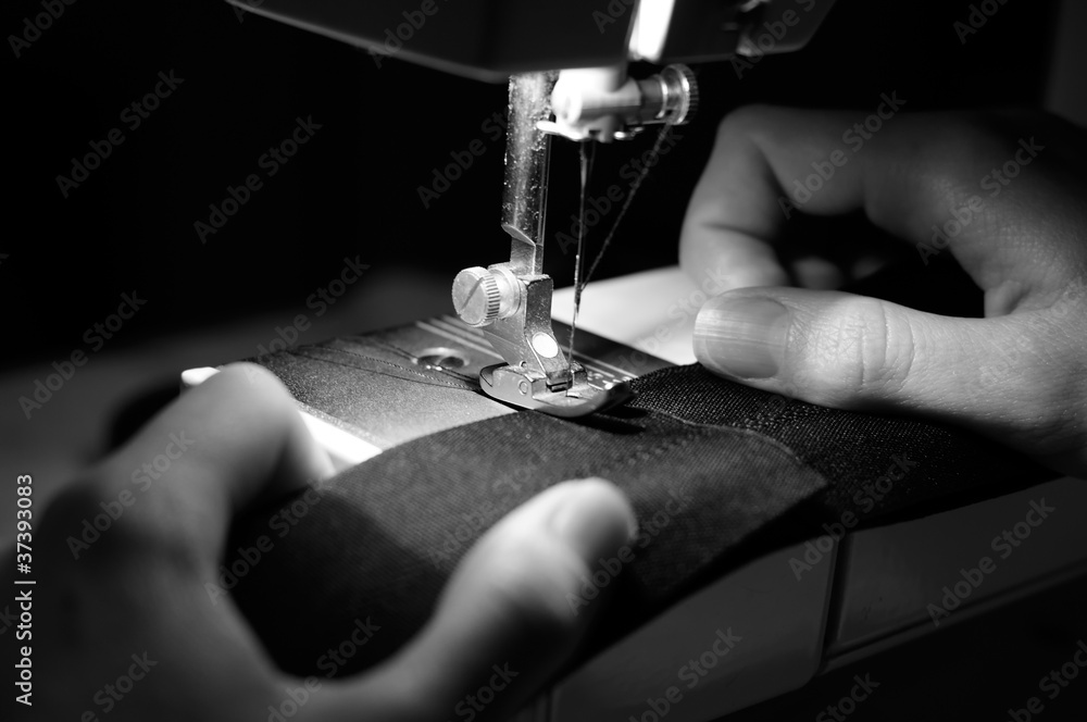 Hands of Seamstress Using Sewing Machine - obrazy, fototapety, plakaty 