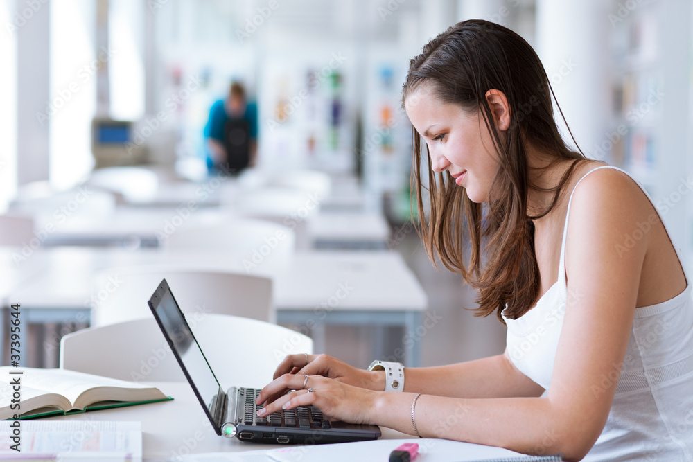pretty female college student studying in the university library pretty female college student studying in the university library