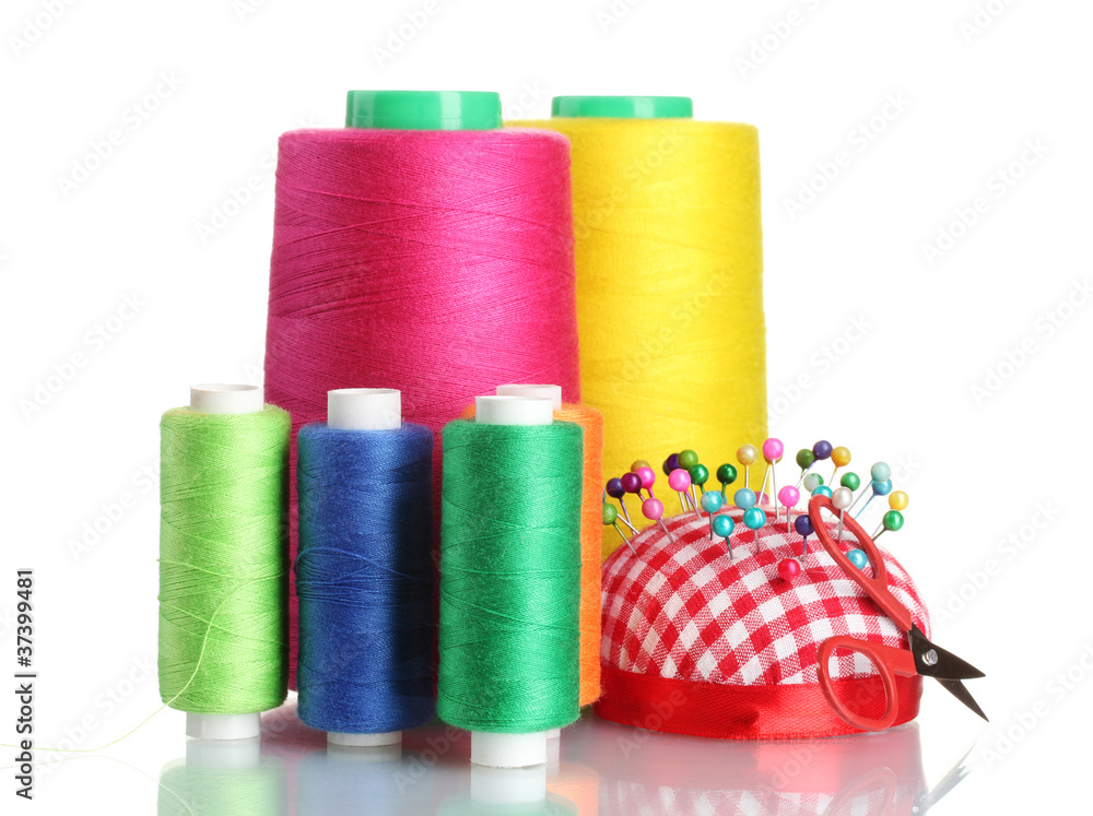 Bobbins of thread with colored pinheads in pin-cushion isolated Bobbins of thread with colored pinheads in pin-cushion isolated