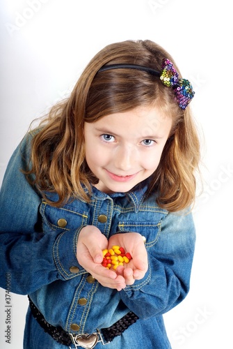 Girl with sweets/tablets photo