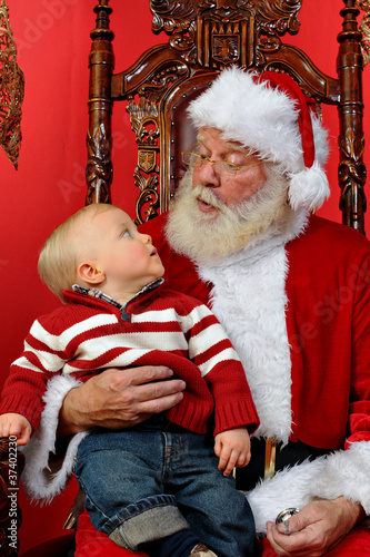 Baby looking up at Santa