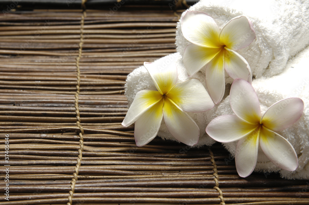 frangipani flower with Frangipani on straw mat frangipani flower with Frangipani on straw mat