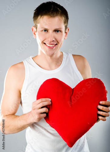 Cute young menl with a red heart