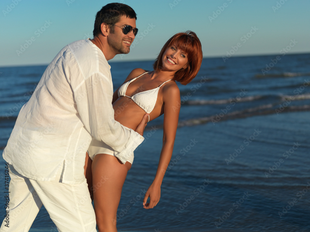 happy, young couple by the sea shore
