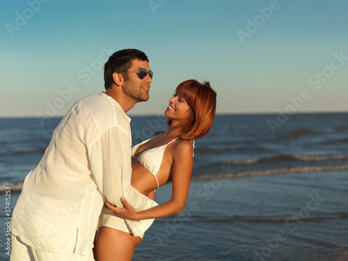 happy, young couple by the sea shore