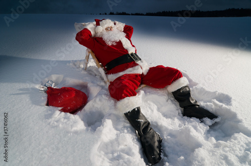 Santa relaxing on a sunbed