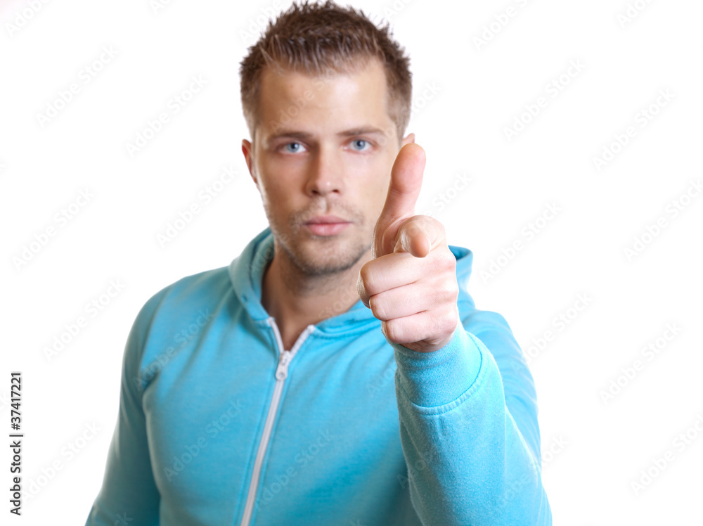 Casual young man pointing a finger Casual young man pointing a finger