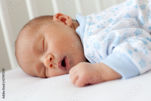 newborn sleeping in a crib