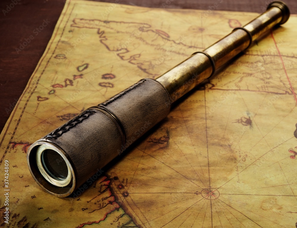 Close-up of a spyglass on the old map