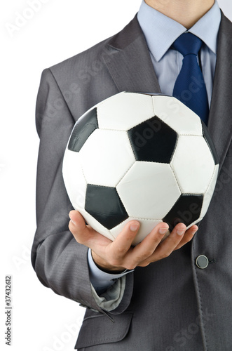 Businessman holding football on white © Elnur