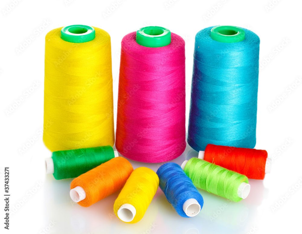 Many-coloured bobbins of thread isolated on white Many-coloured bobbins of thread isolated on white