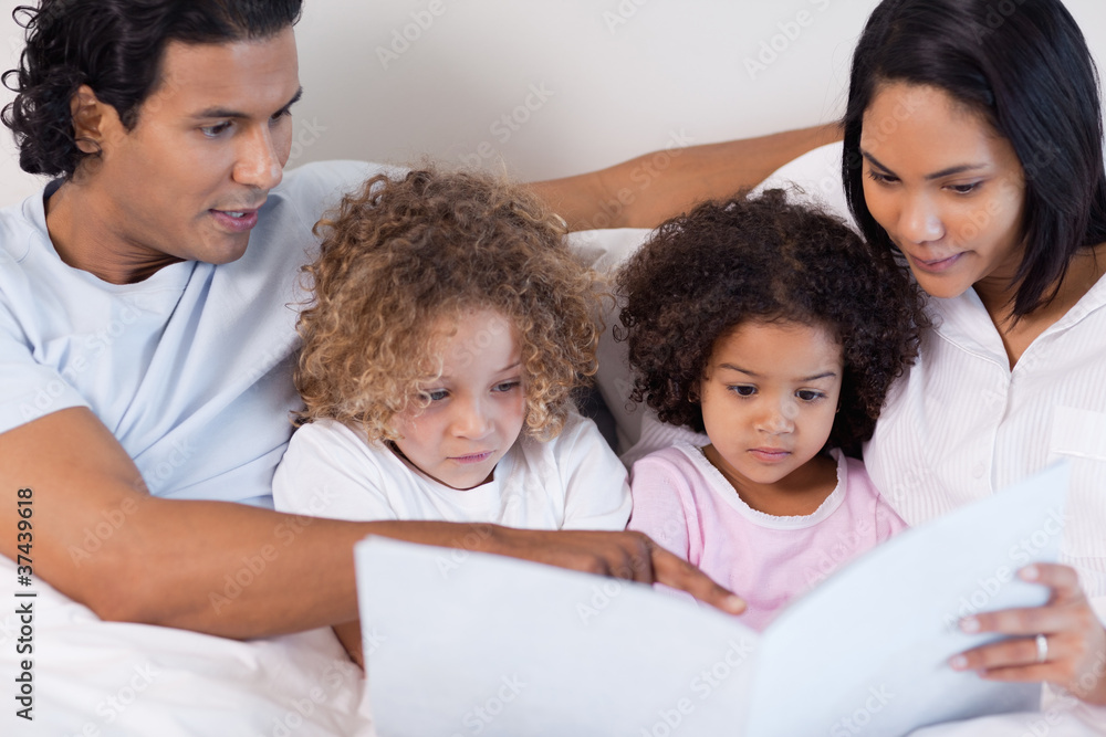 Parents reading a story for their children Parents reading a story for their children