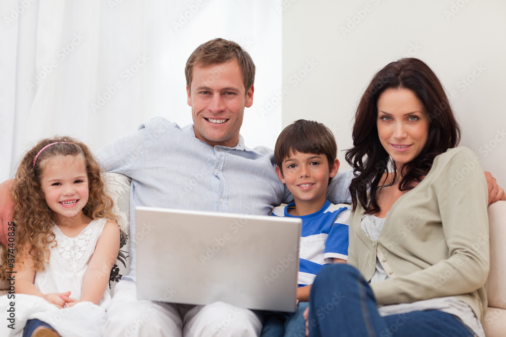 Family surfing the internet in the living room together Family surfing the internet in the living room together