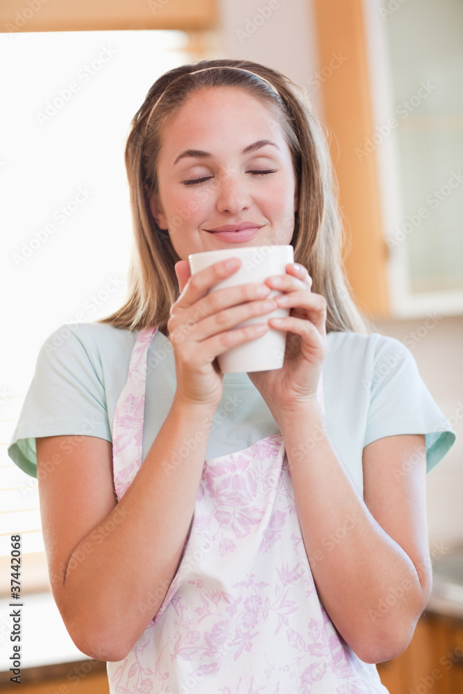 Portrait of a quiet woman drinking a cup of tea Portrait of a quiet woman drinking a cup of tea