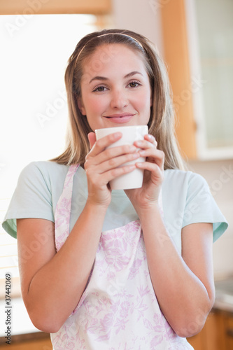 Fototapeta Naklejka Na Ścianę i Meble -  Portrait of a quiet woman drinking a cup of coffee
