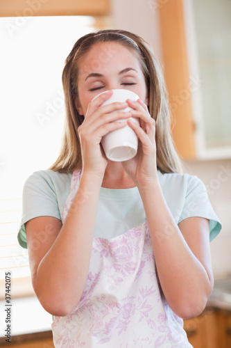Portrait of a calm woman drinking a cup of tea