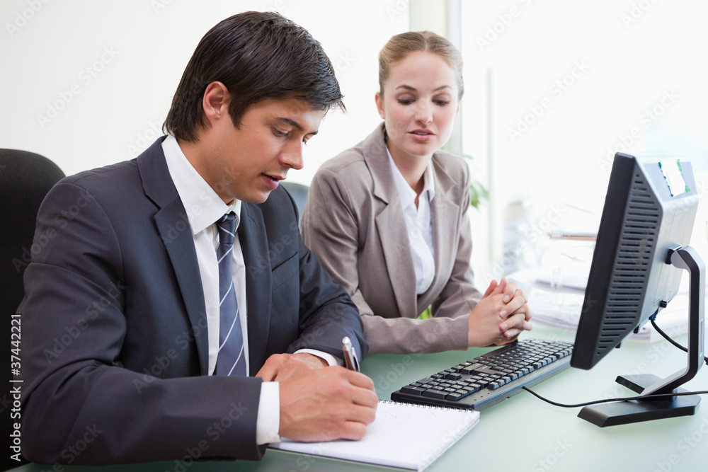 Serious business people working with a computer Serious business people working with a computer