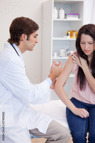 Patient getting an injection by male doctor