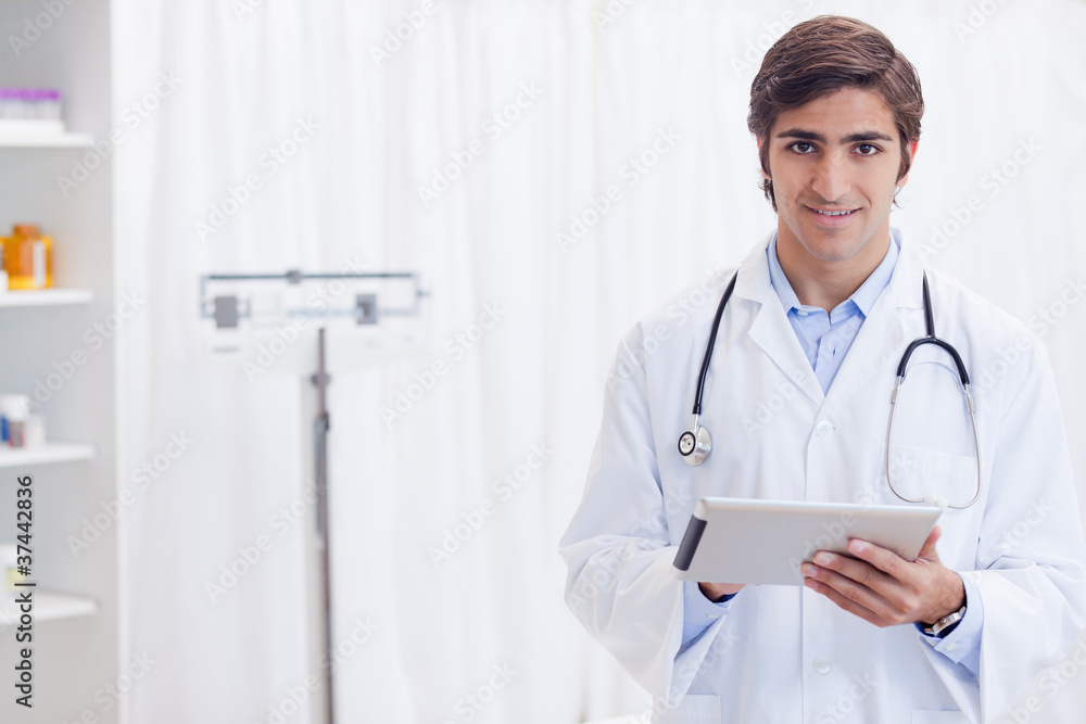 Smiling doctor with tablet Smiling doctor with tablet