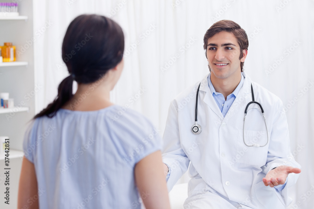 Physician having a conversation with patient Physician having a conversation with patient
