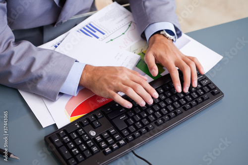 Hands typing on keyboard