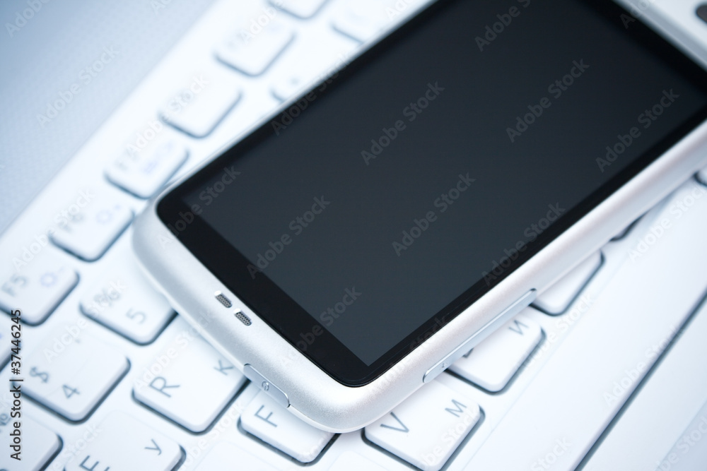 smart phone on laptop smart phone on laptop