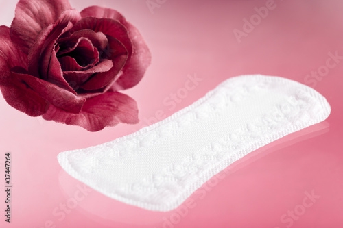 Panty Liner with Rose on Pink Background photo