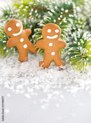 smiling gingerbread man with christmas tree branch